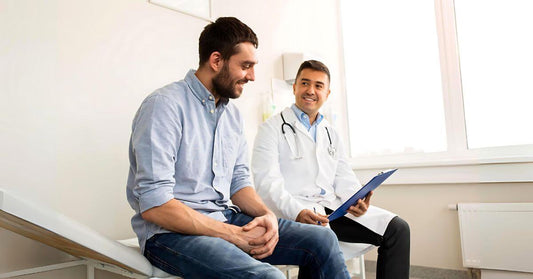 Man discussing BMI and body fat measurements with a doctor during a health consultation